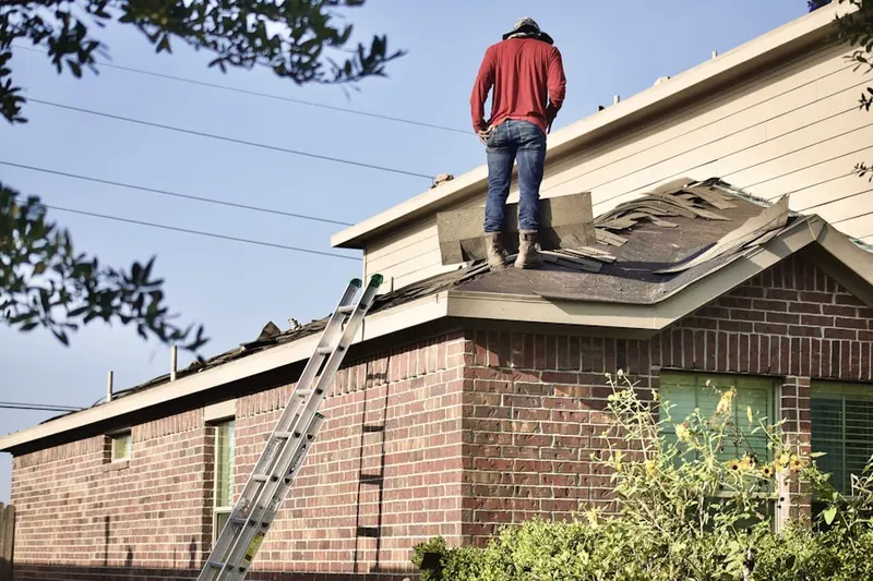 Professional roofer working on a residential roof in Ithan